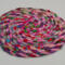 This view shows a different angle of the trivet. It is approximately 1/4 inch thick.